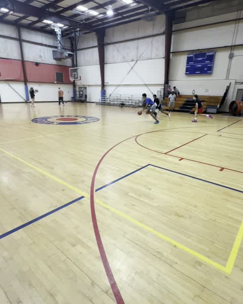 Players dribbling downcourt during a session