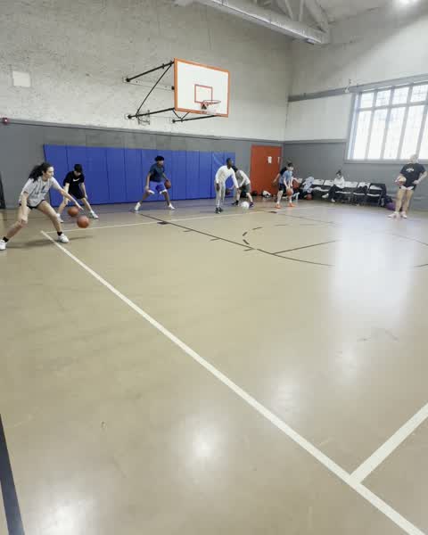 Group dribbling warmup on the court